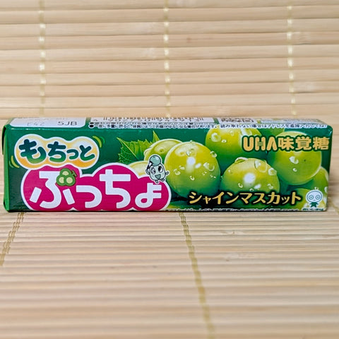 A pack of UHA Puccho Shine Muscat Grape candy chews on a tatami background.