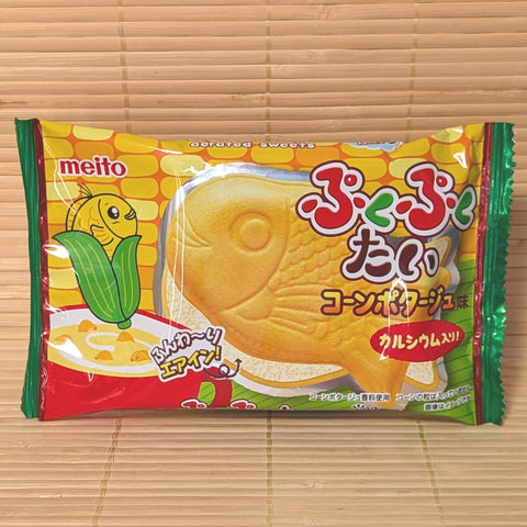 A brightly colored package of Puku Puku Tai Corn Potage flavor showing the fish-shaped wafer on a bamboo mat.