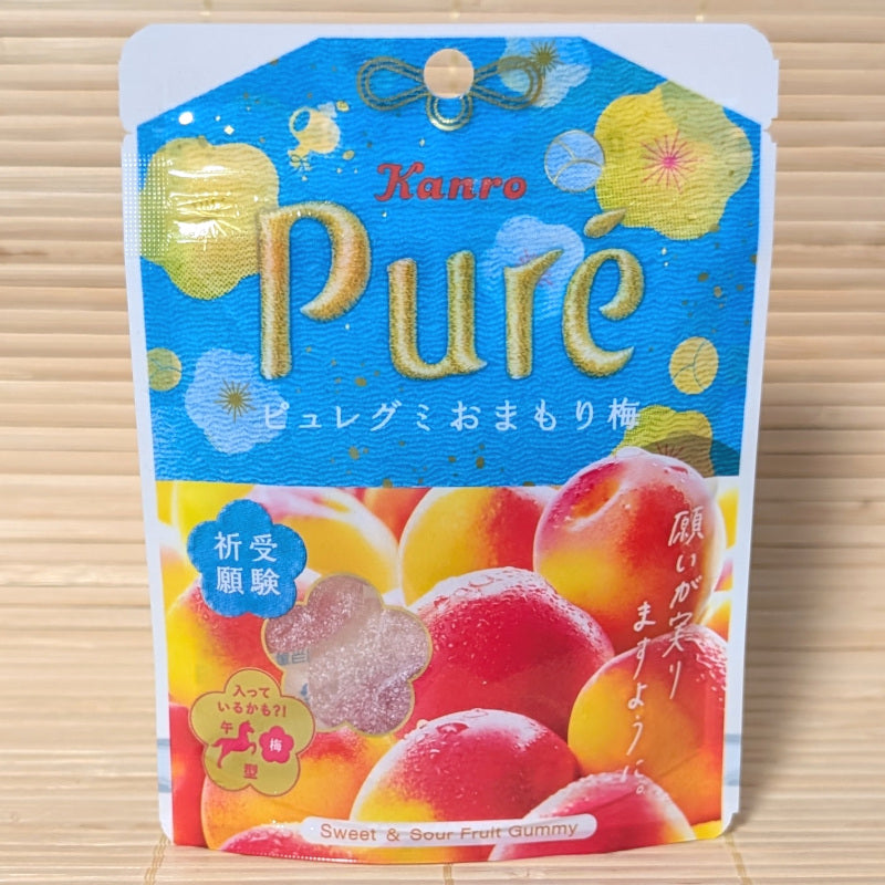 A pack of Kanro Pure Ume plum apricot gummy candy package on a wooden surface