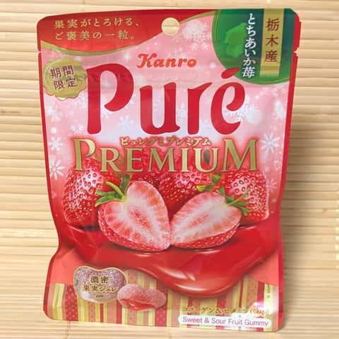 Kanro Pure Premium strawberry gummy package on a wooden background