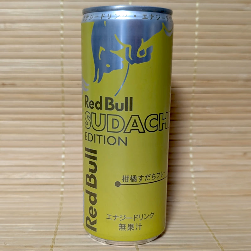 A lime-green 250ml can of Japanese Red Bull Sudachi Edition energy drink displaying Japanese text and the iconic charging bulls logo against a textured background.
