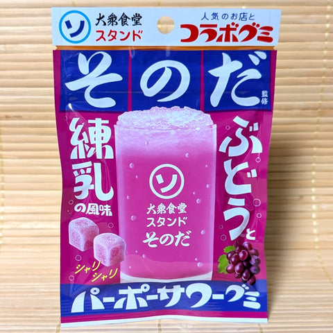 A retro looking packet of Red Grape Condensed Milk flavored Sonoda Gummies displayed on a tatami background.