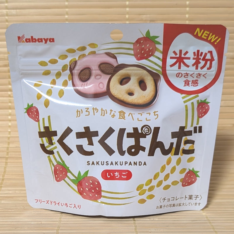 A white stand-up pouch of Saku Saku Panda Strawberry Chocolate Cookies with rice flour and strawberry graphics on a bamboo mat background.