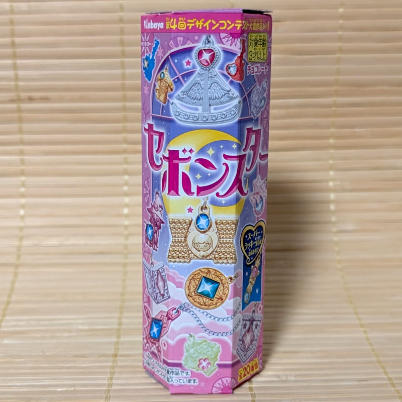 A pink hexagonal box of Kabaya Sebon Star showing various colorful heart and star-shaped jewelry charms.