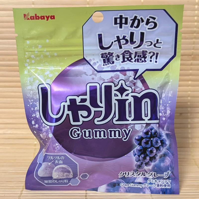 A green and purple pouch of Kabaya Shari-in Gummy in Crystal Red Grape flavor showing the crunchy grain center.