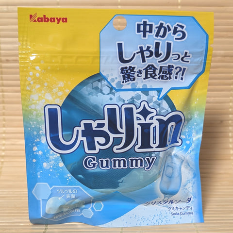 A blue and yellow resealable pouch of Kabaya Shari-in Soda Gummy featuring crystal soda graphics, photographed on a traditional Japanese tatami background.