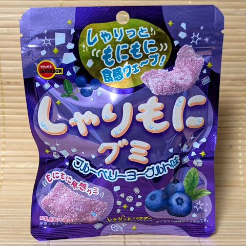 A blueberry yogurt flavored pack of Bourbon Sharimoni Gummy candy. The bright purple pack is displayed on a tatami background.