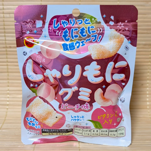A pack of Sharimoni Peach Gummies displayed on a tatami background.