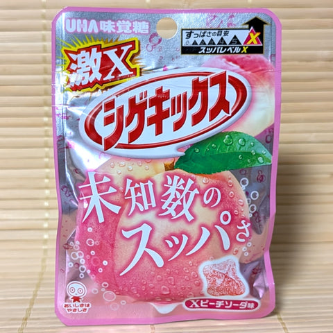 Pink packaging of Shigekix Peach Soda on wooden surface