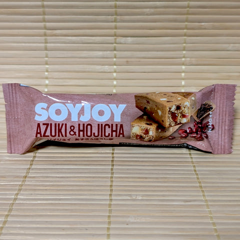 A light brown SoyJoy wrapper for the Azuki and Hojicha flavor, featuring a cross-section of the bar showing whole beans and tea leaves.