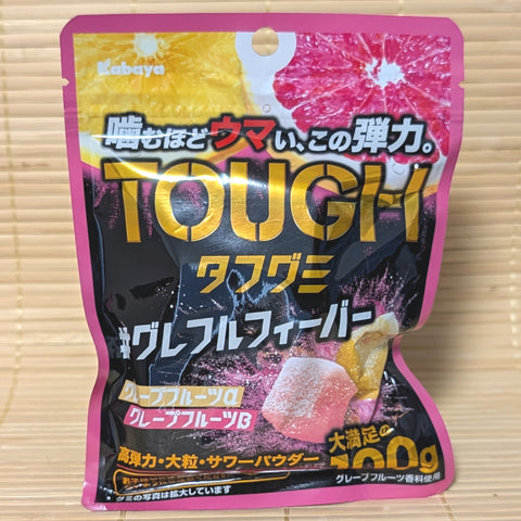 A hot pink and black resealable pouch of Kabaya TOUGH Gummy Grapefruit Fever showing yellow and pink grapefruit slices on a tatami background.