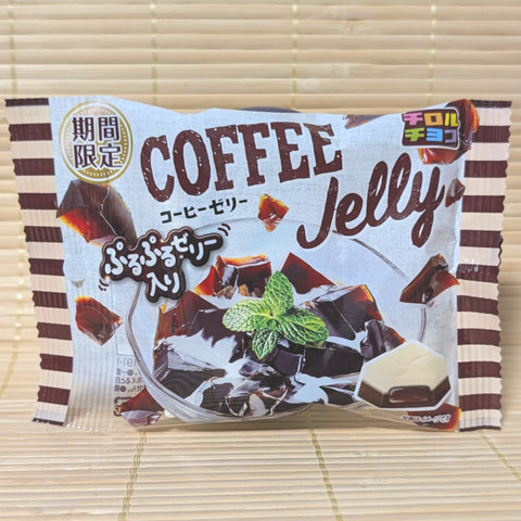 A white and brown striped Tirol Chocolate bag on a tatami background showing coffee jelly in a glass and a cross-section of the chocolate square.