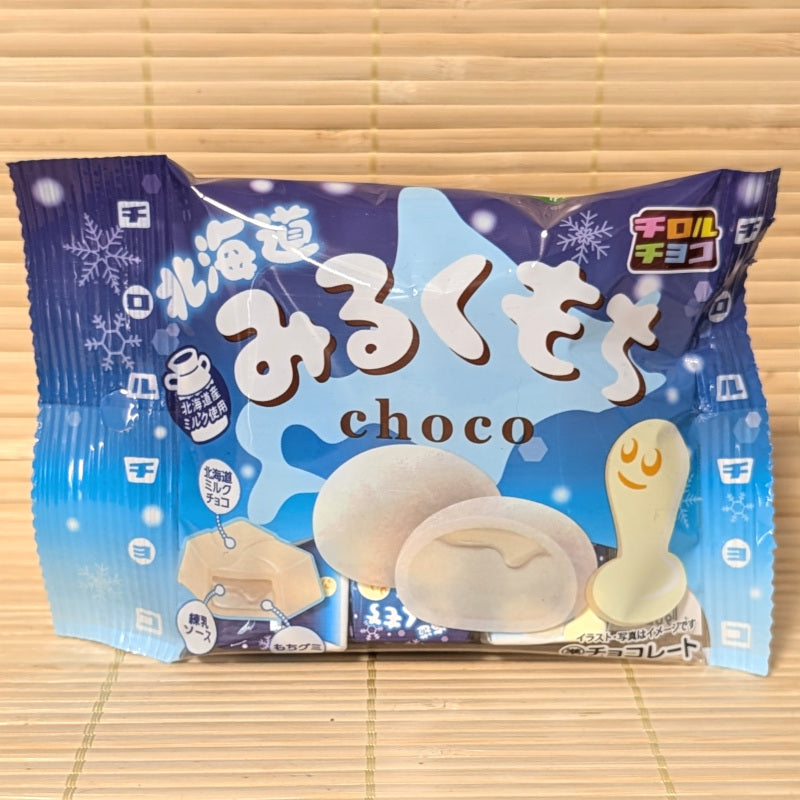 A blue winter designed pack of mini Tirol Chocolates featuring Hokkaido Milk Mochi. Displayed on a bamboo background.