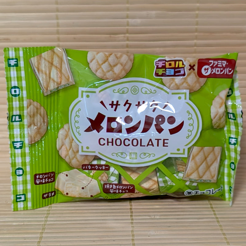 A green pouch of Tirol Saku Saku Melon Pan chocolates featuring melon pan graphic illustrations on a bamboo mat.