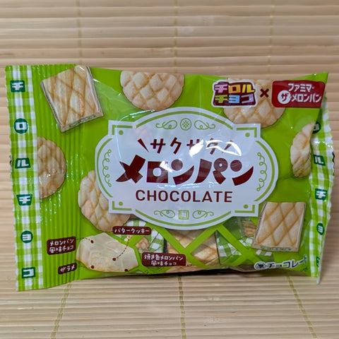 A green pouch of Tirol Saku Saku Melon Pan chocolates featuring melon pan graphic illustrations on a bamboo mat.