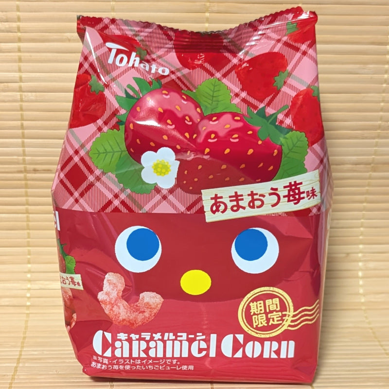 Red package of Tohato Caramel Corn with strawberries and Tohato branding on a wooden background