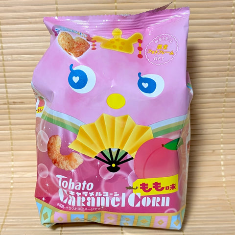Pink bag of Tohato Caramel Corn with a peach theme and the iconic character face.