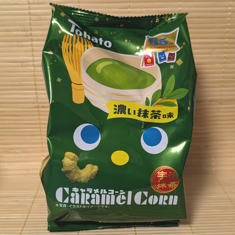 A package of Tohato Caramel Corn in a dark green bag with illustrations of green tea and matcha powder.


