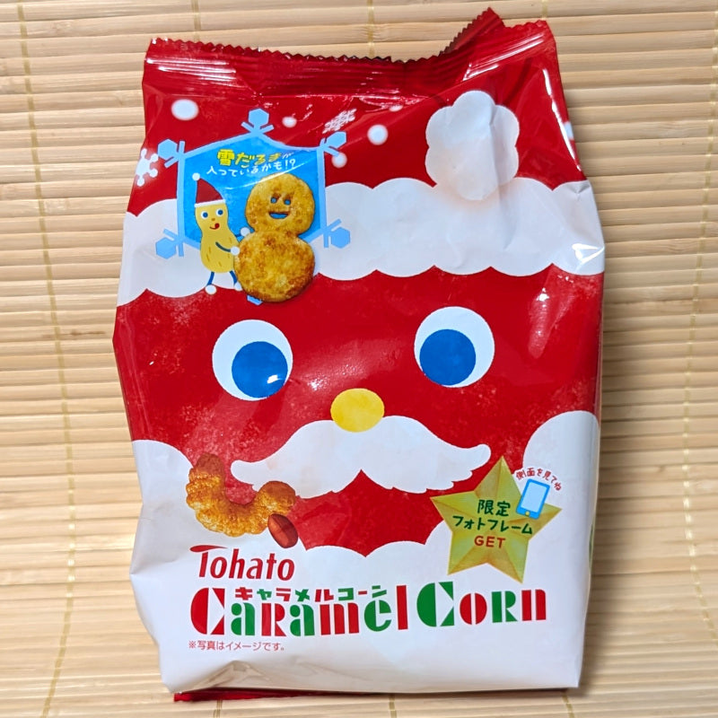 Red package of Tohato Caramel Corn with Santa Claus face on a wooden surface