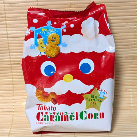 Red package of Tohato Caramel Corn with Santa Claus face on a wooden surface