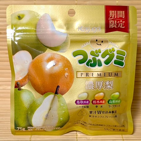 A golden metallic pouch of Kasugai Tsubugumi Premium Rich Pear Gummy Mix featuring graphics of fresh pears on a bamboo mat background.