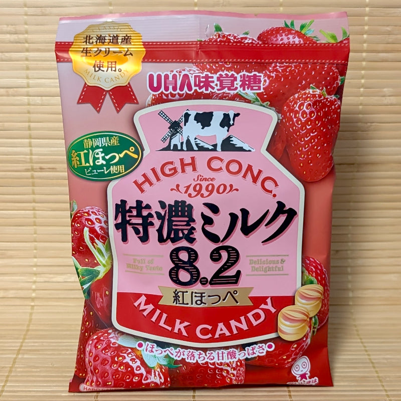 Pink 75g bag of UHA Tokunou Milk 8.2 Benihoppe Strawberry hard candies featuring fresh cream and ripe red strawberry graphics.