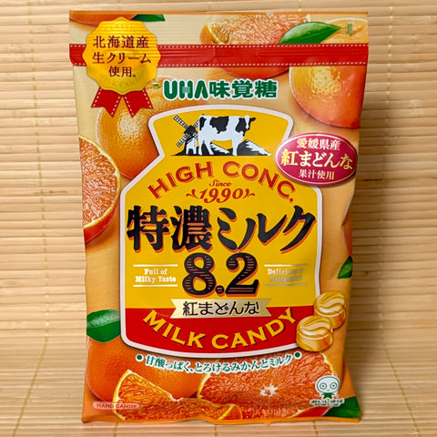 Bright orange 70g bag of UHA Tokunou Milk 8.2 Beni Madonna Orange hard candies featuring fresh cream and ripe citrus graphics.