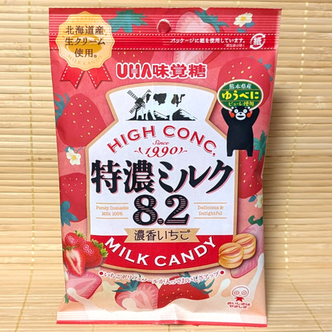 An UHA Milk candy package with strawberry condensed milk flavor on a wooden background